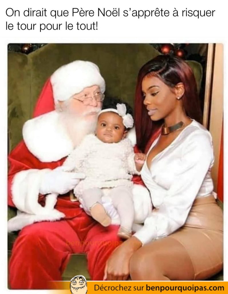 Une belle femme noire assise sur e père noël avec son enfant
